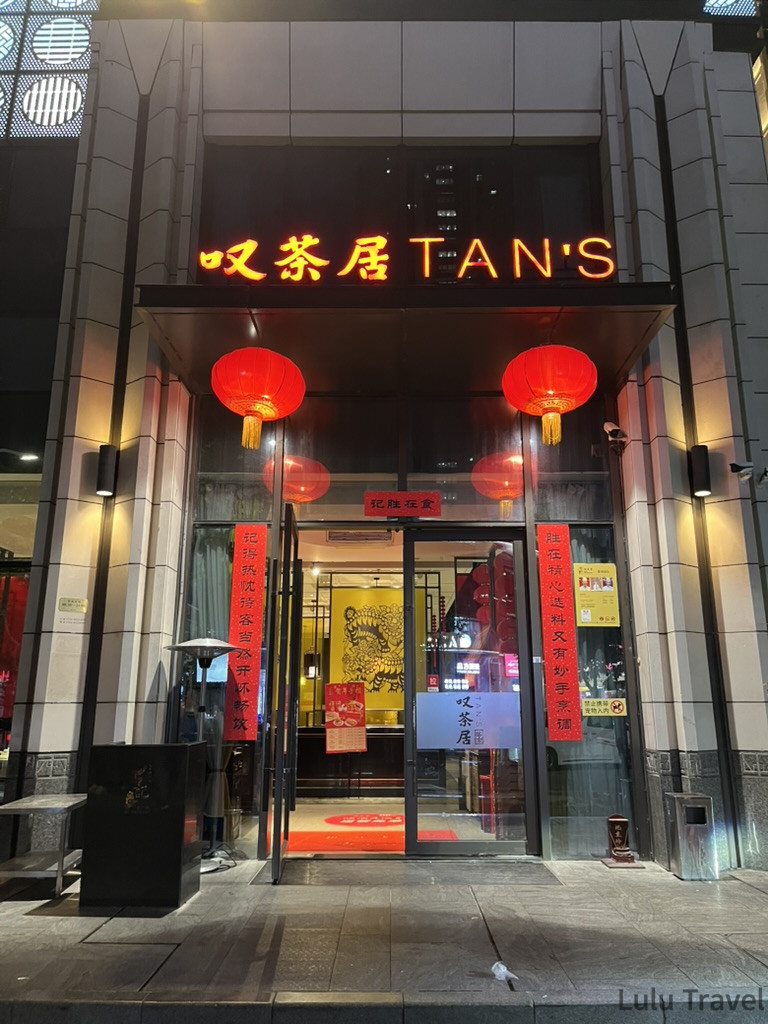 深圳出差廠商招待的餐廳「叭茶居 TAN'S」夜間門口，入口兩側掛有紅色燈籠與春聯，金色招牌在夜色中醒目