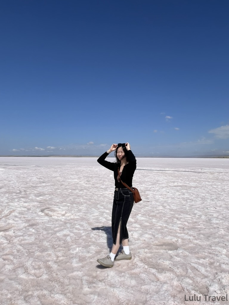 土耳其鹽湖（Tuz Gölü）的超現實景象，遊客站在平坦白色湖面，天空與湖面相映成趣，是土耳次跟團行程中最夢幻的地質奇蹟
